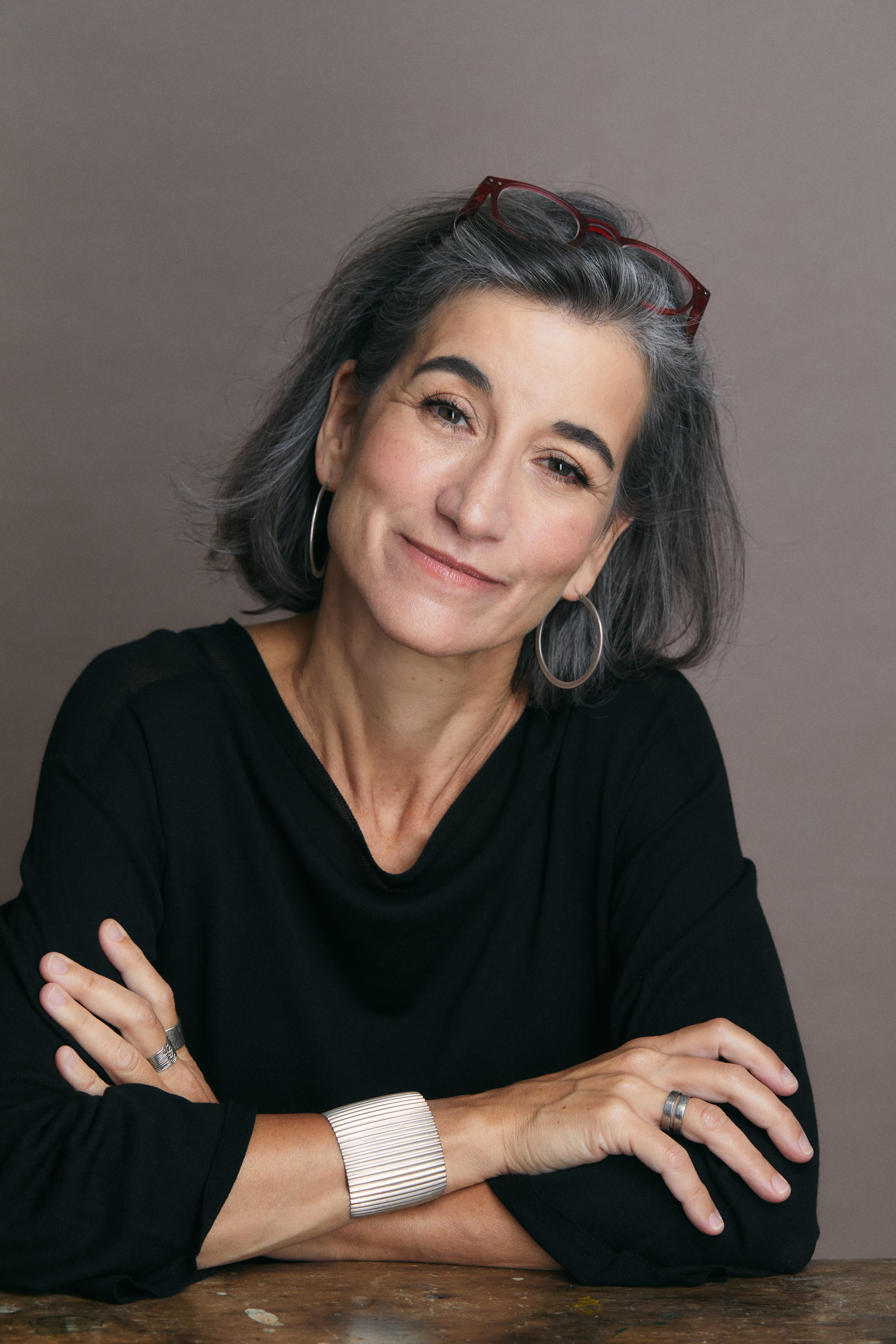 Producer Yael Melameade looking directly at camera and smiling.