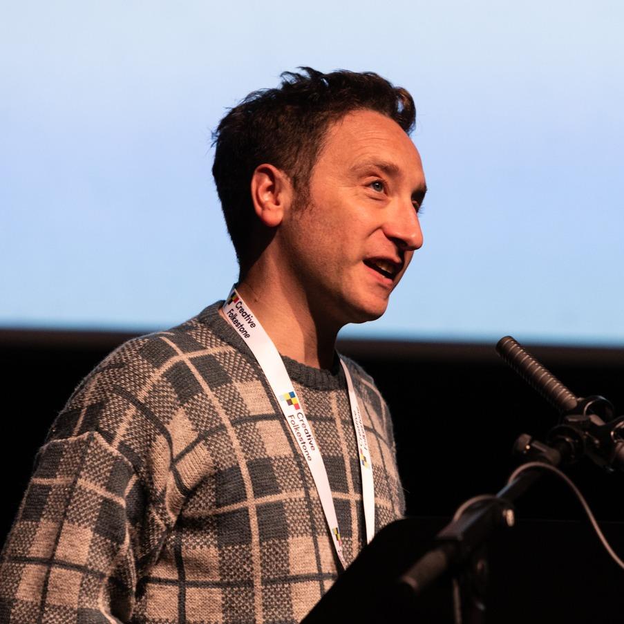 Charlie Phillips speaks at a microphone.