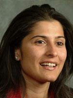 Sharmeen Obaid Chinoy looks past the camera smiling.