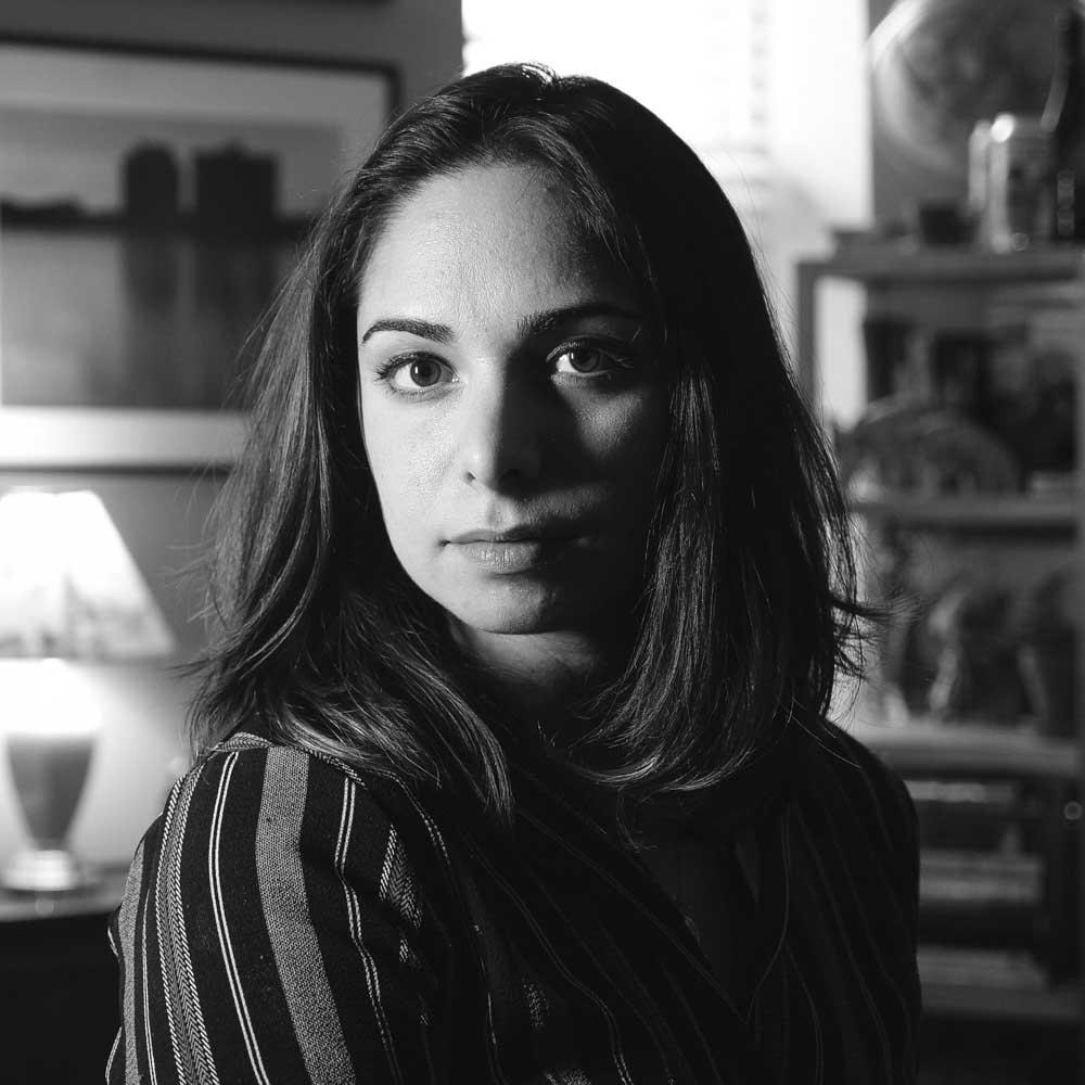 A black and white portrait of a woman looking into the camera.