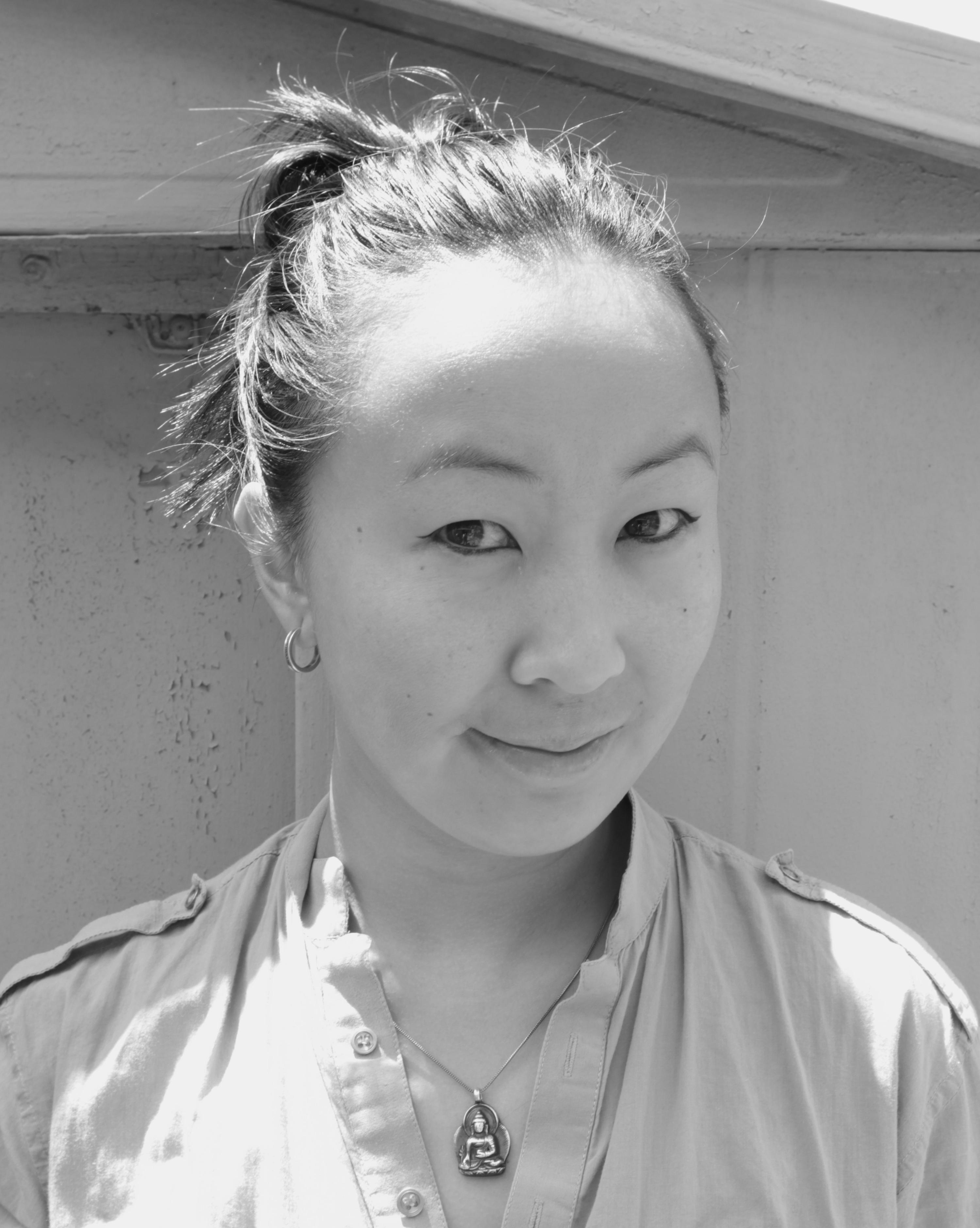 Tiffany Hsuing looks directly at the camera. Portrait in black and white.