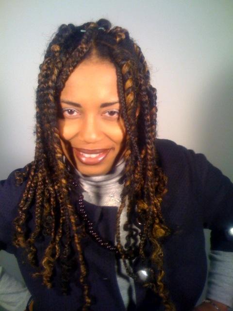 A portrait of a woman smiling into the camera in front of a white backdrop.