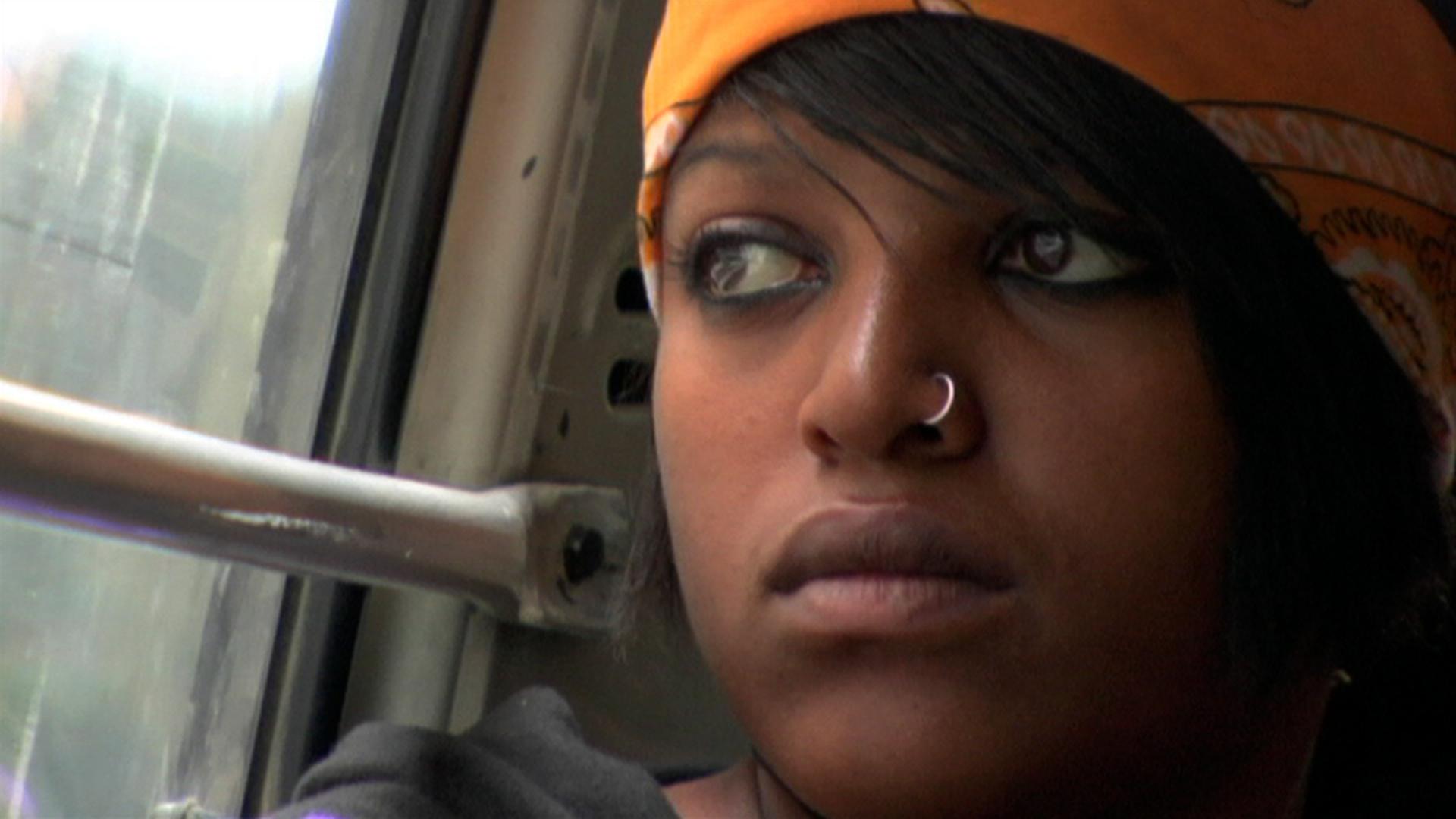 A closeup of a young girl looking out a window.