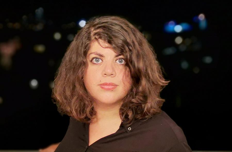 Sonia Ben Slama is looking directly at the camera. Portrait, background out of focus.