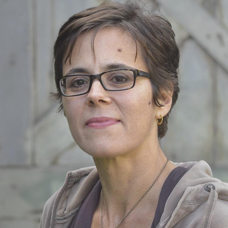 portrait of a woman with glasses and brown hair.